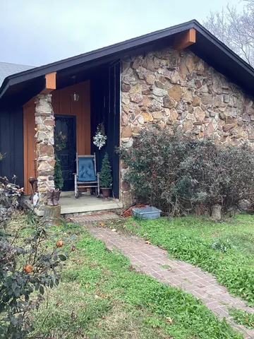 a view of a wooden door with a yard