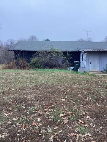 a view of a backyard with furniture and a barn
