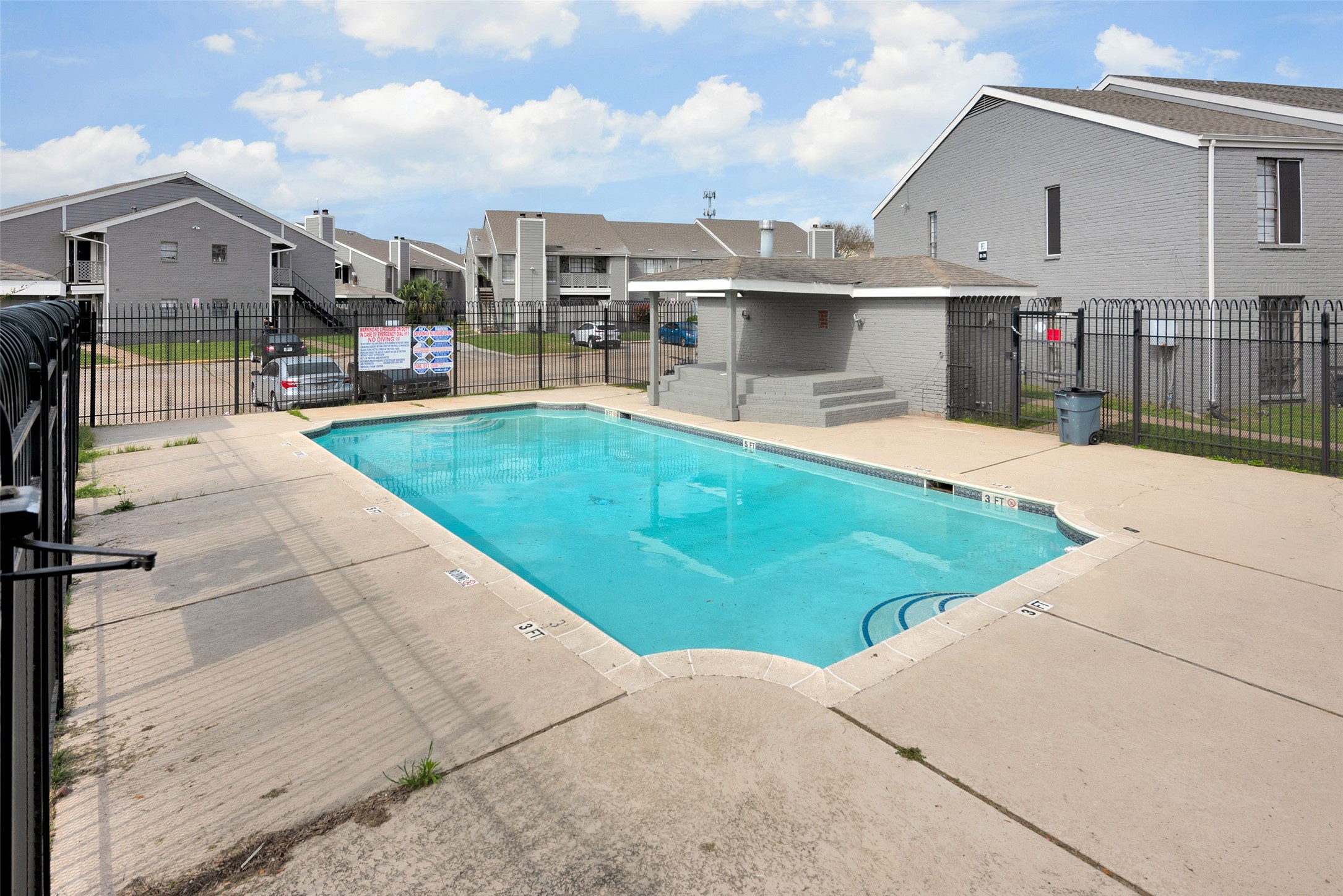 12500 Sandpiper Drive, Unit 186 Houston, TX 77035 - Photo 5 of 10 a view of a white house with a swimming pool and porch