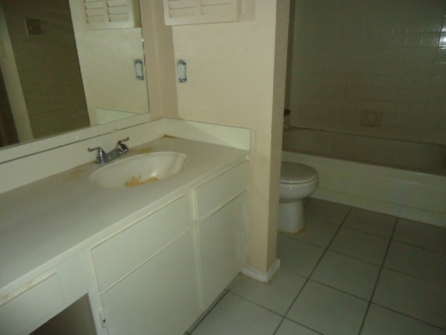 12500 Sandpiper Drive, Unit 186 Houston, TX 77035 - Photo 10 of 10 a bathroom with a sink a toilet and a mirror