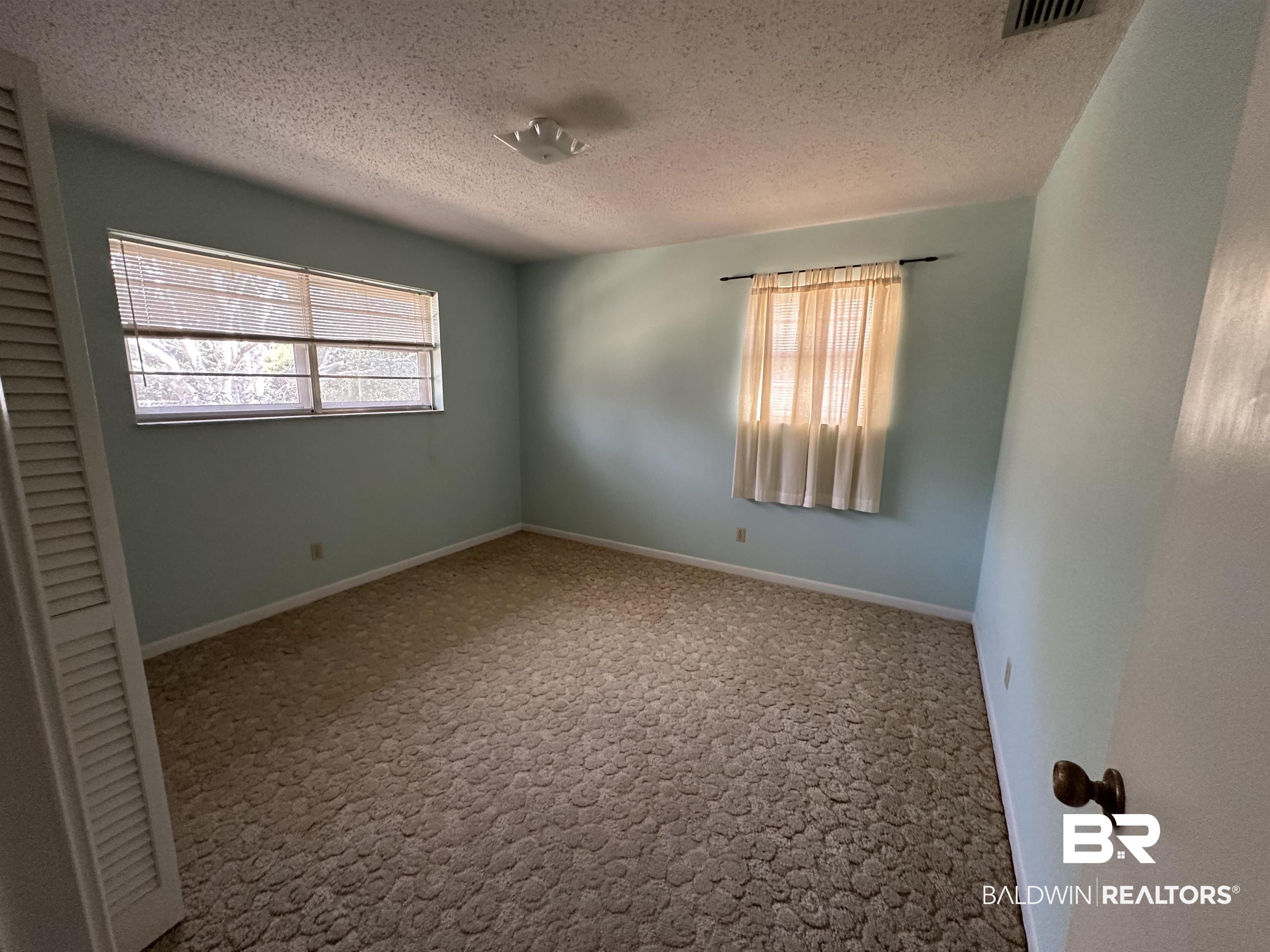 1 Yupon Circle Foley, AL 36535 - Photo 18 of 30 Empty room featuring a textured ceiling and baseboards
