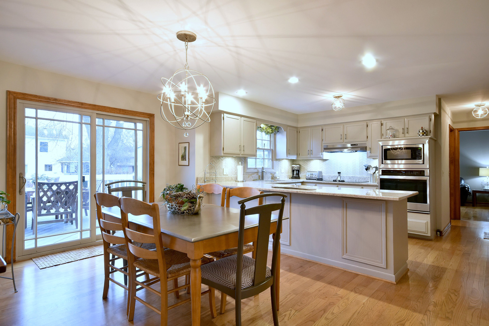 2535 Sun Valley Road Lisle, IL 60532 - Photo 17 of 54 a kitchen with stainless steel appliances a dining table chairs and wooden floor
