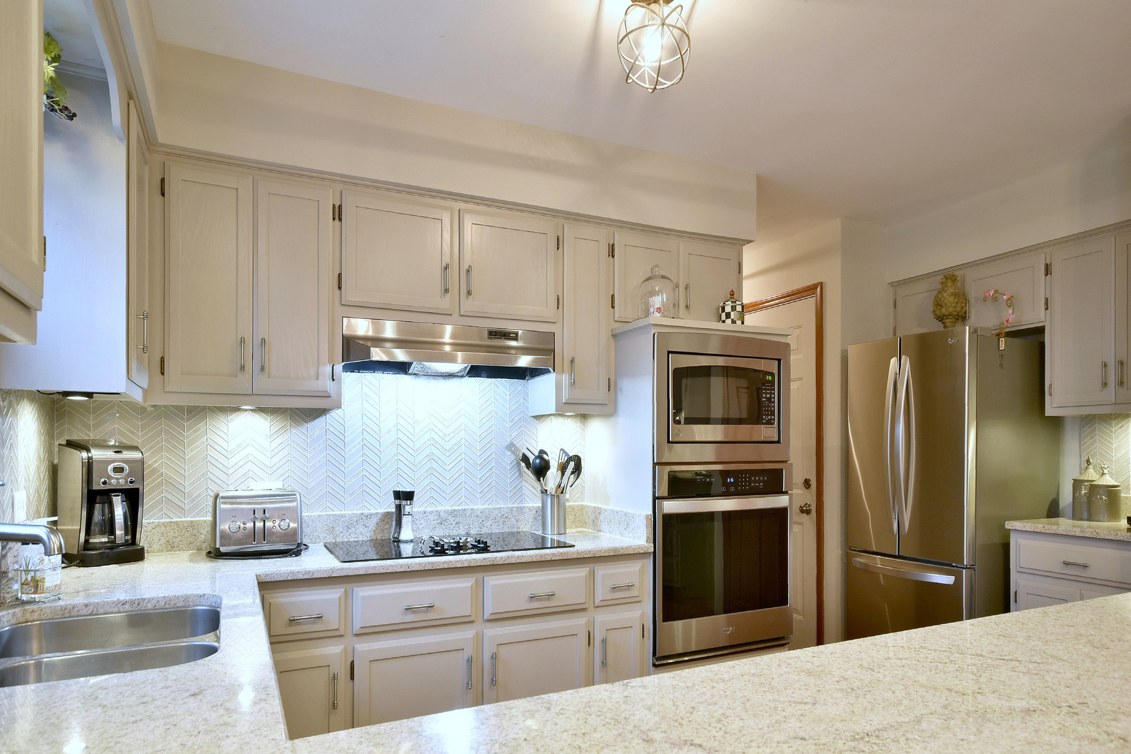 2535 Sun Valley Road Lisle, IL 60532 - Photo 19 of 54 a kitchen with kitchen island granite countertop a refrigerator oven a sink dishwasher and white cabinets with wooden floor