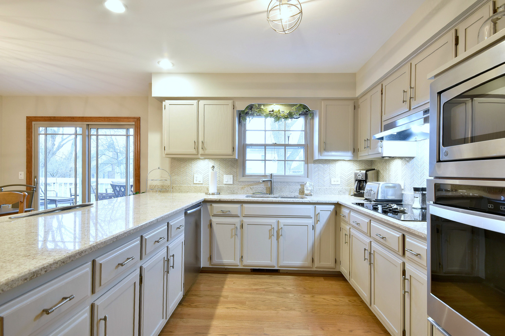 2535 Sun Valley Road Lisle, IL 60532 - Photo 20 of 54 a large kitchen with stainless steel appliances granite countertop a sink and cabinets