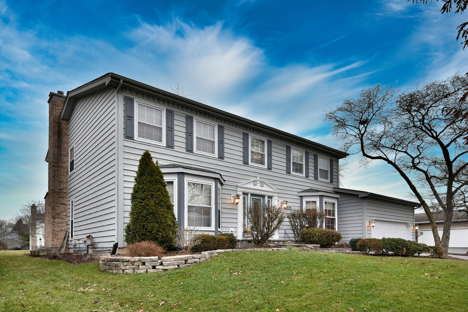 2535 Sun Valley Road Lisle, IL 60532 - Photo 2 of 54 a front view of a house with a yard and trees
