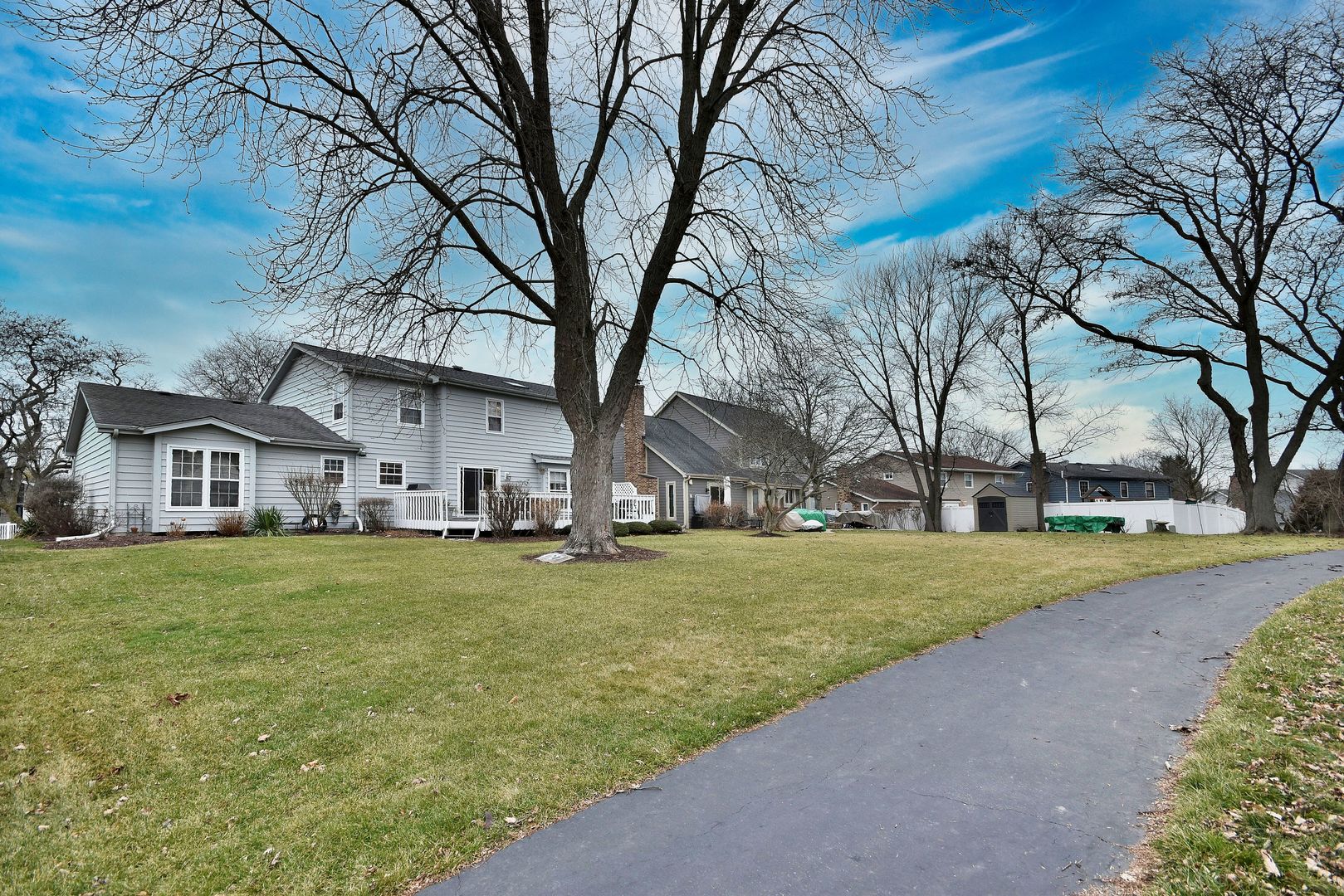 2535 Sun Valley Road Lisle, IL 60532 - Photo 49 of 54 a big house with trees in front of it