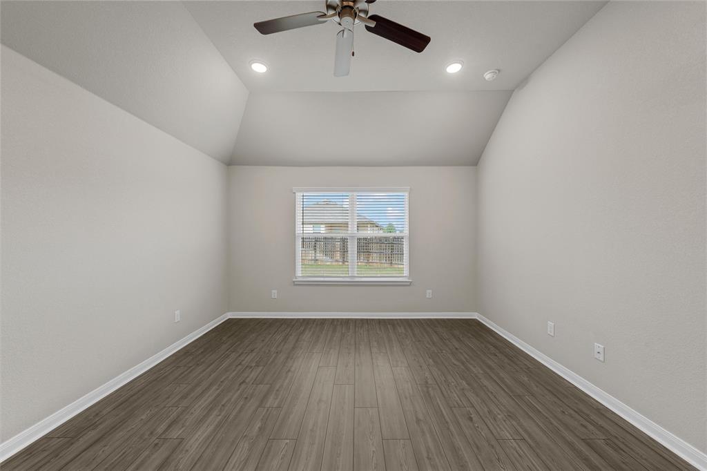 3208 Dottavio Road Lorena, TX 76655 - Photo 16 of 31 Spacious interior room featuring a vaulted ceiling with recessed lighting and a ceiling fan, wood-finish flooring, a window with blinds, and light-toned wall finishes