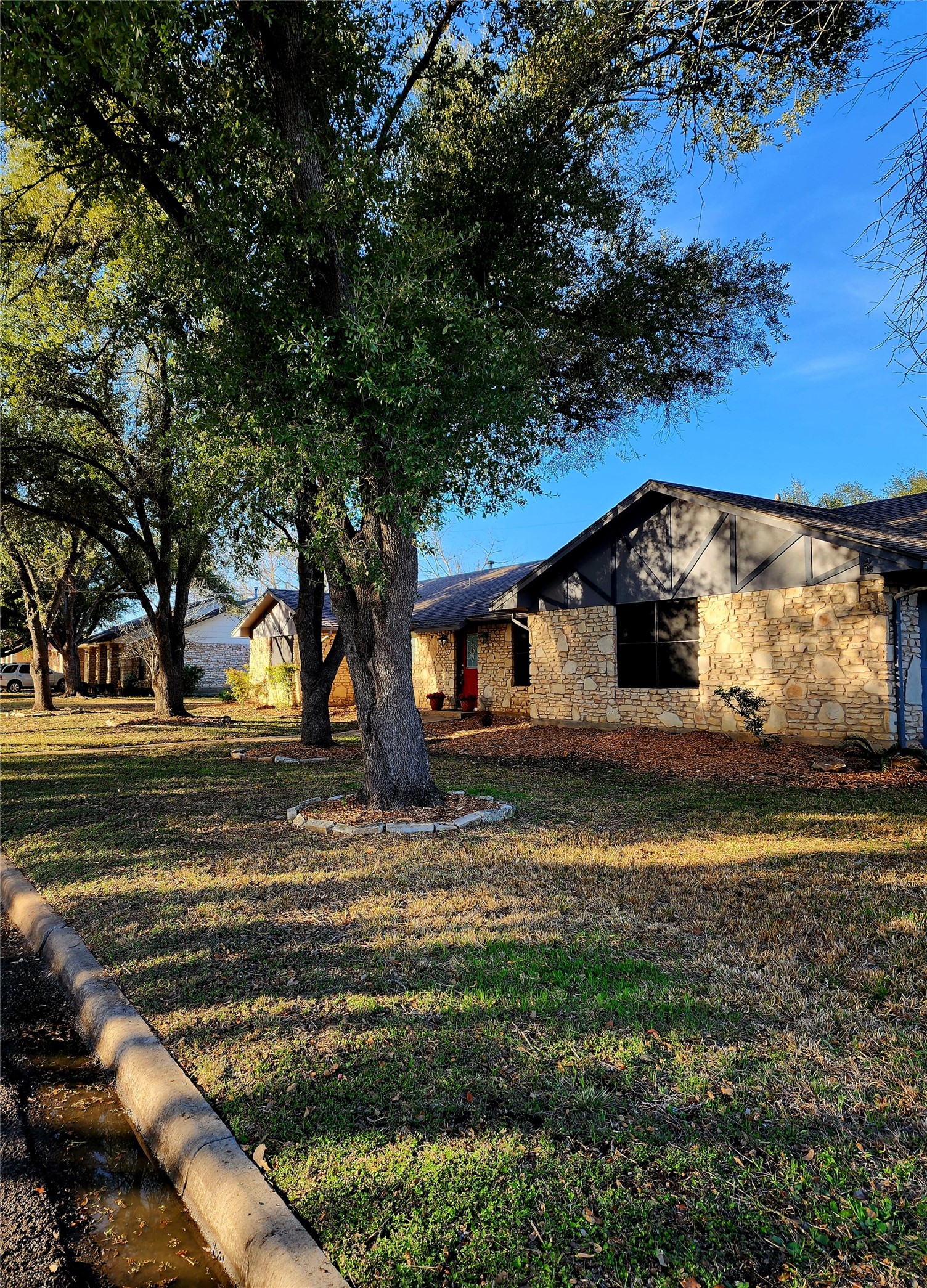 2000 Donna Drive Taylor, TX 76574 - Photo 3 of 27 a view of a yard in front of a house with large trees