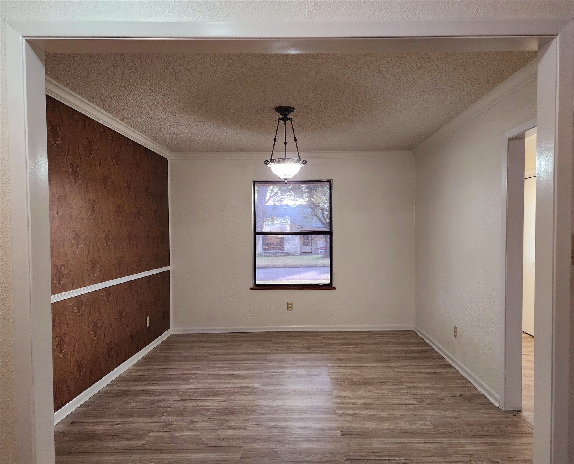 2000 Donna Drive Taylor, TX 76574 - Photo 9 of 27 a view of an empty room with wooden floor and a window