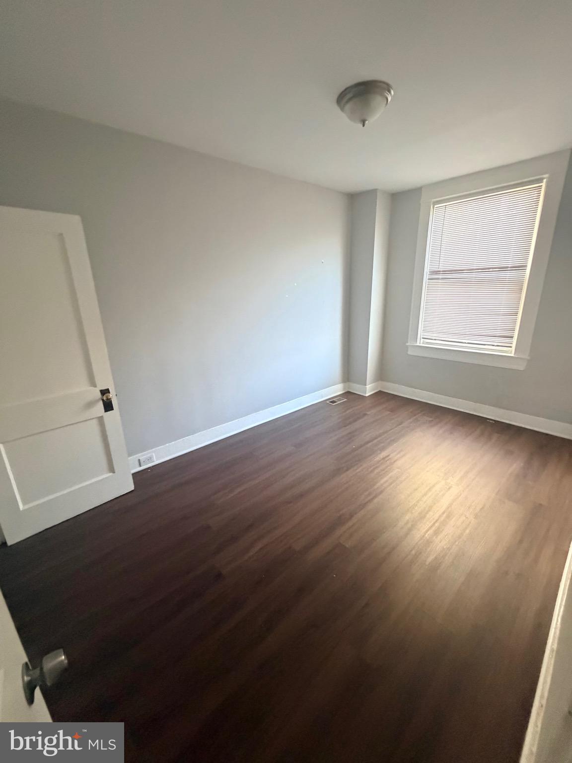 412 East Cold Spring Lane Baltimore, MD 21212 - Photo 3 of 8 an empty room with wooden floor and windows