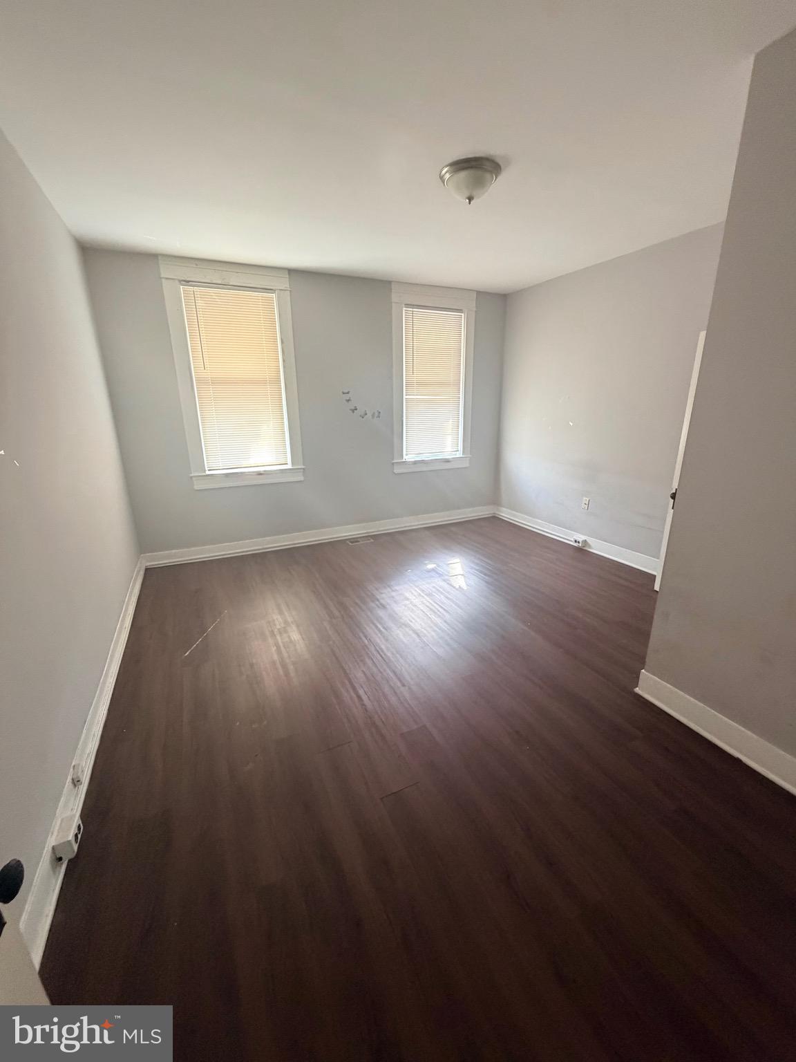 412 East Cold Spring Lane Baltimore, MD 21212 - Photo 4 of 8 a view of an empty room with wooden floor and a window