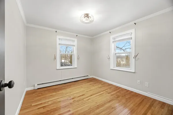 a view of a room with a wooden floor and a window