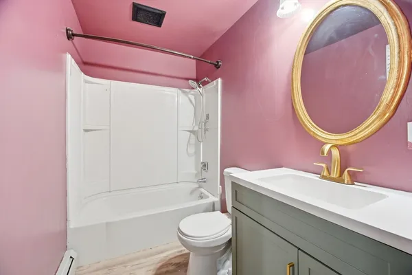 a bathroom with a sink a toilet and a mirror