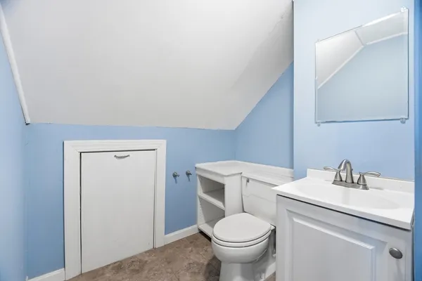 a bathroom with a sink a toilet and a mirror