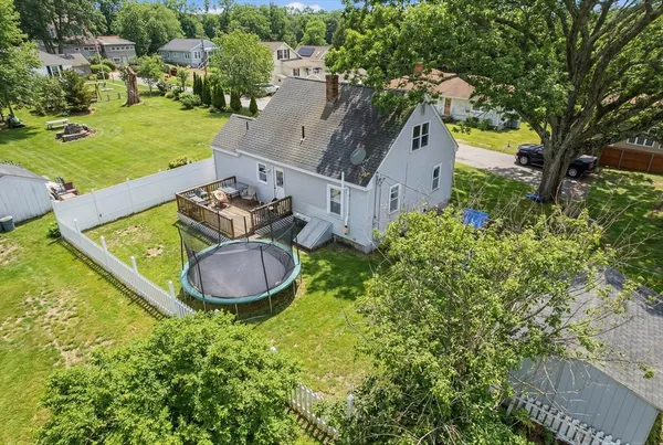 an aerial view of a house with garden space and street view