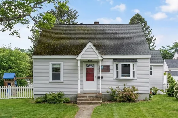 a view of a house with a yard and potted plants