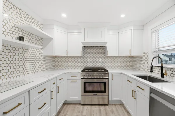 a kitchen with a sink stove and cabinets