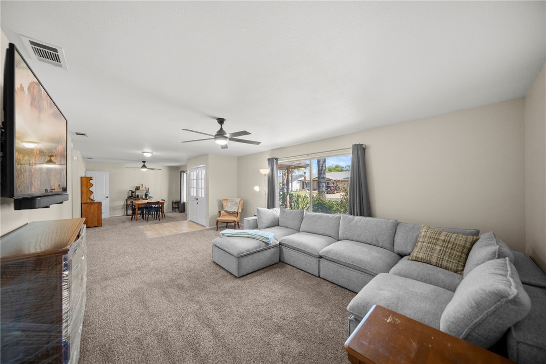 27879 Foxfire Street Menifee, CA 92586 - Photo 11 of 36 a living room with furniture and a large window