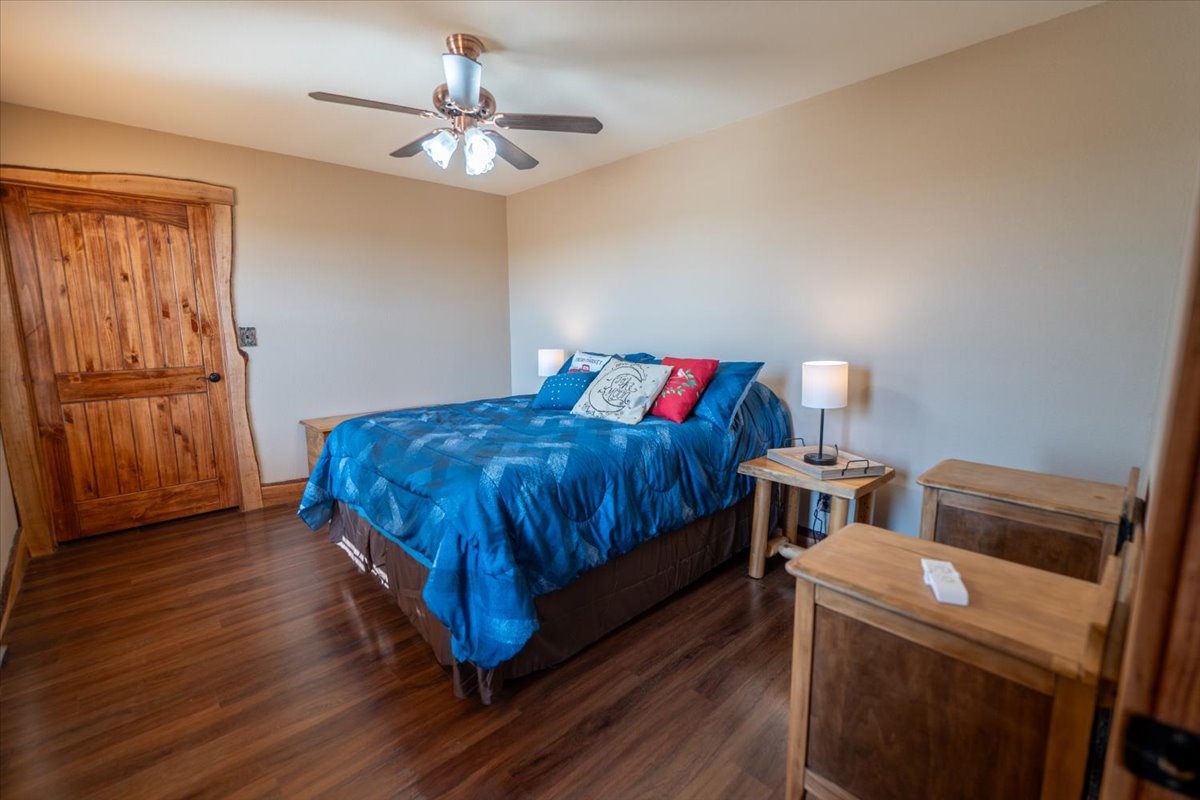 1825 Savanna Ridge Ranch Road Lometa, TX 76853 - Photo 18 of 35 Bedroom with dark wood finished floors and a ceiling fan