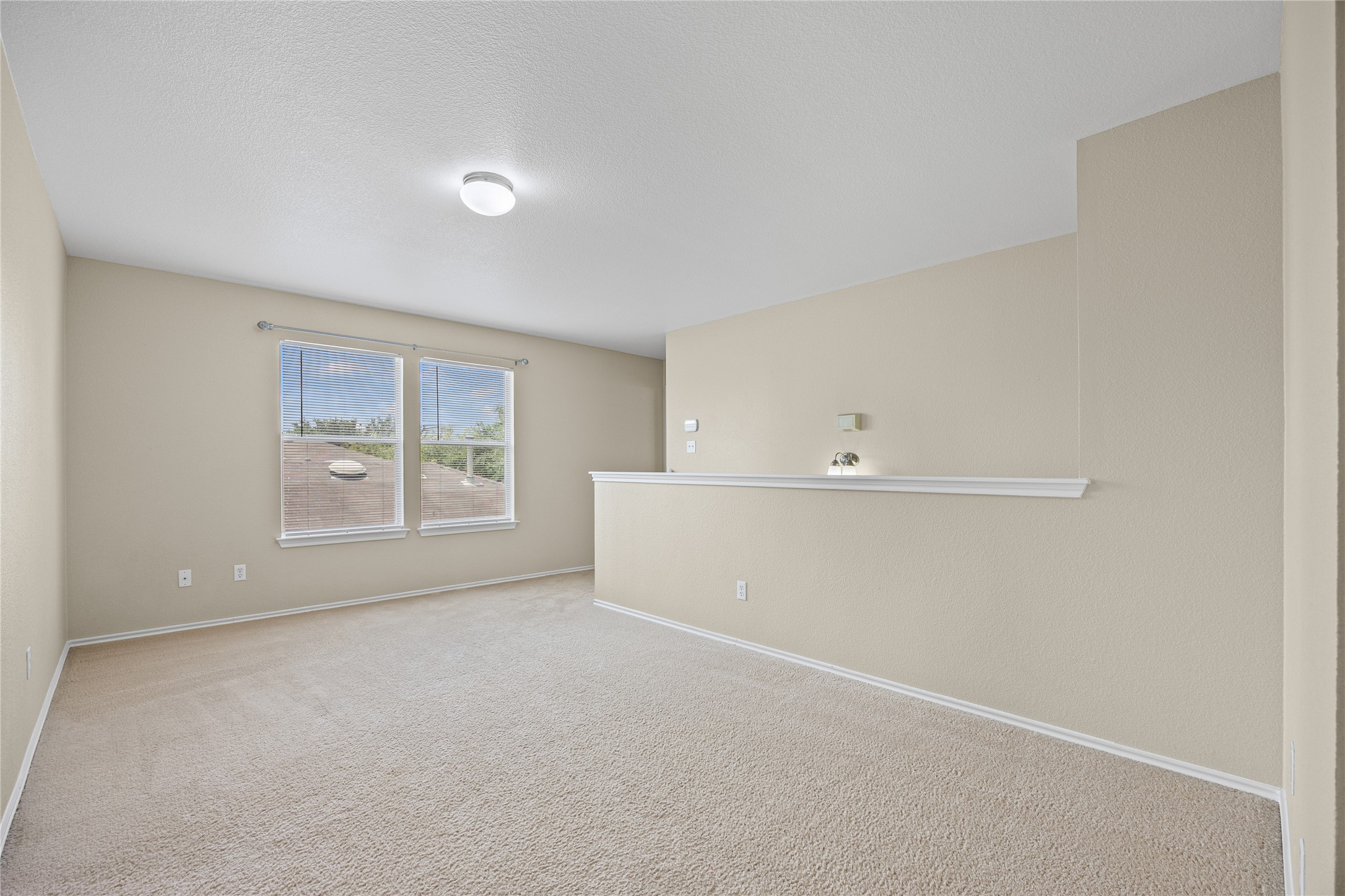 198 Black Forest Road Buda, TX 78610 - Photo 11 of 23 A well-lit area with plush carpeting offers versatile living space and elevated views.