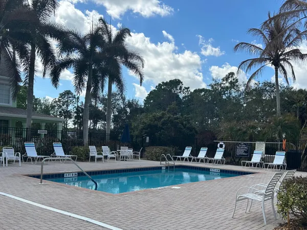 a view of a house with swimming pool and sitting area