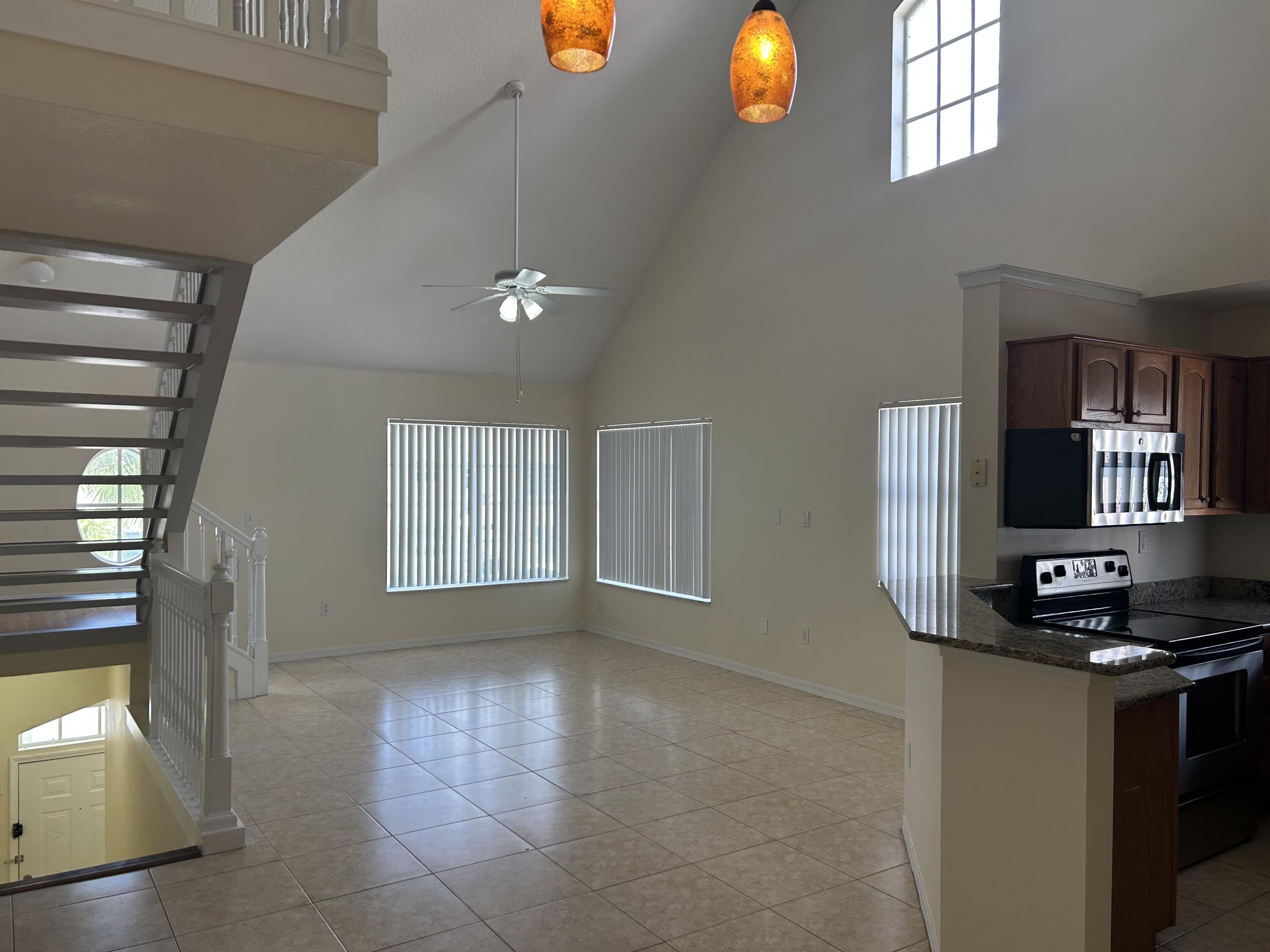 1687 Southeast Pomeroy Street Stuart, FL 34997 - Photo 3 of 20 a kitchen with a refrigerator and window