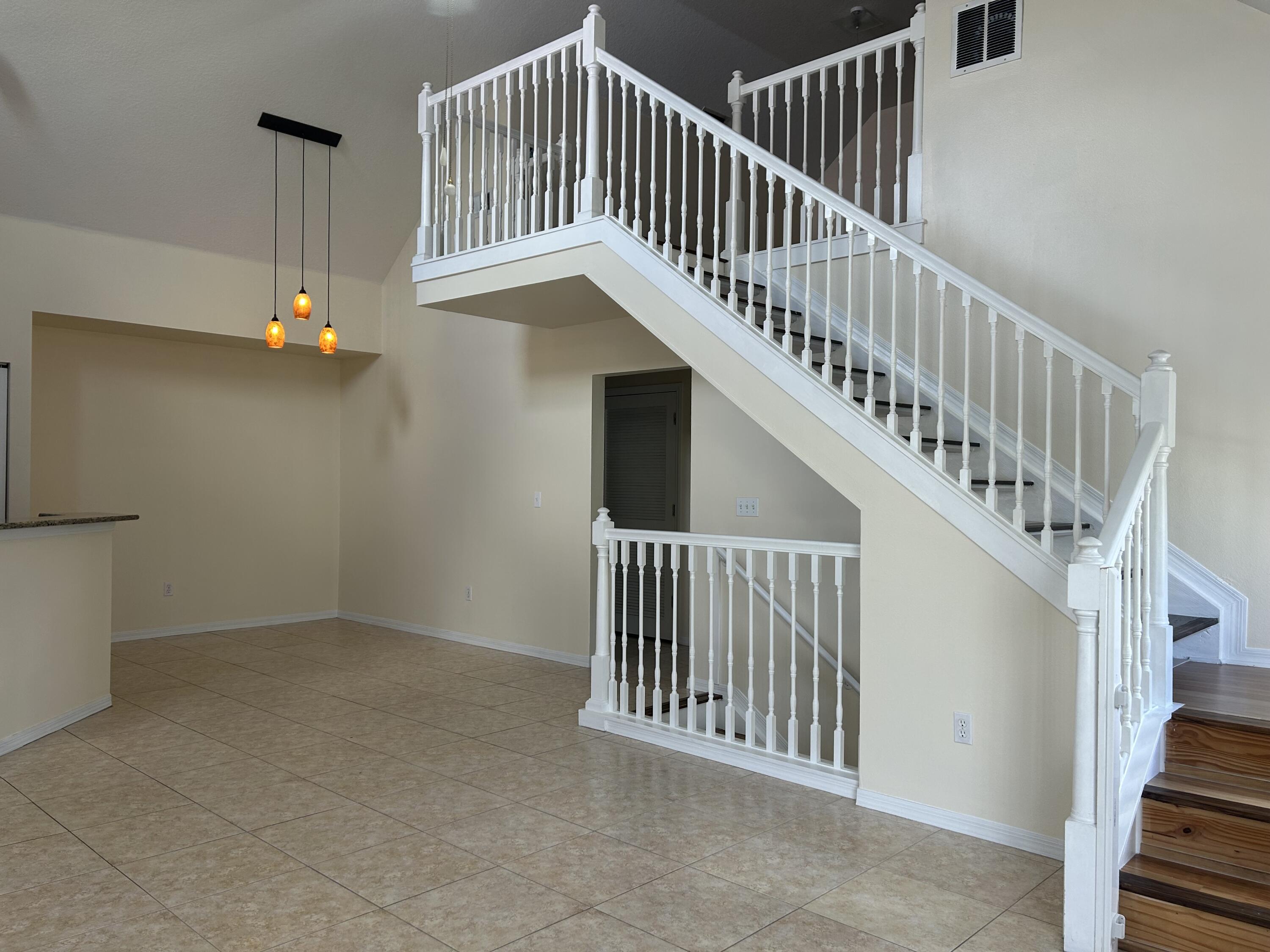 1687 Southeast Pomeroy Street Stuart, FL 34997 - Photo 6 of 20 a view of staircase with railing and white walls