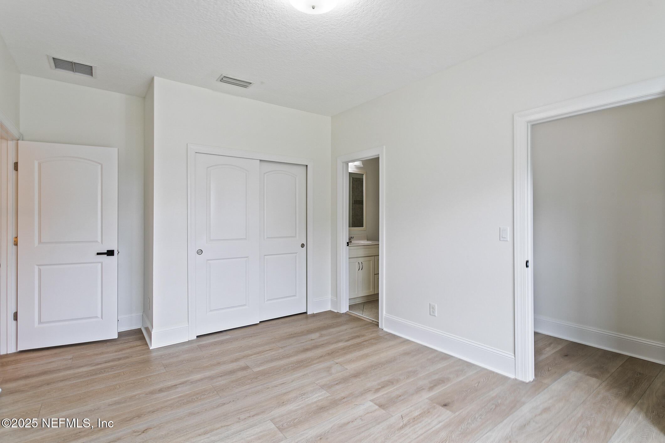 124 Mollusk Road St. Johns, FL 32259 - Photo 62 of 94 a view of an empty room and wooden floor