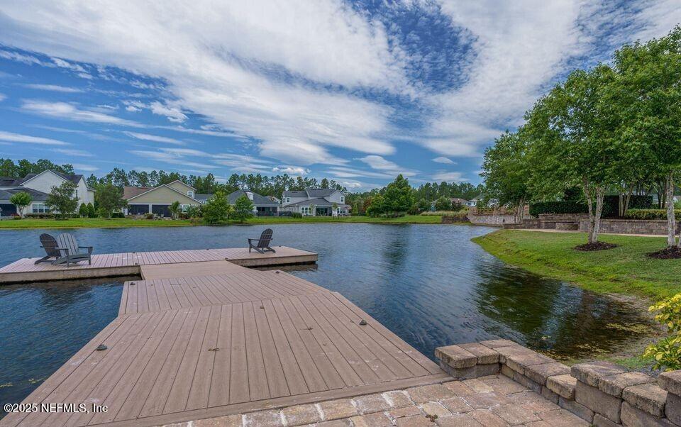 124 Mollusk Road St. Johns, FL 32259 - Photo 94 of 94 a view of a lake with a yard and a wooden deck