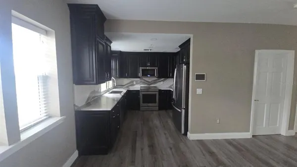 a view of a kitchen from the hallway