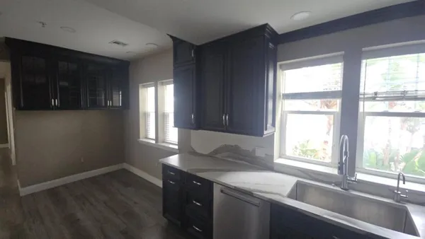 a kitchen with a sink and large window