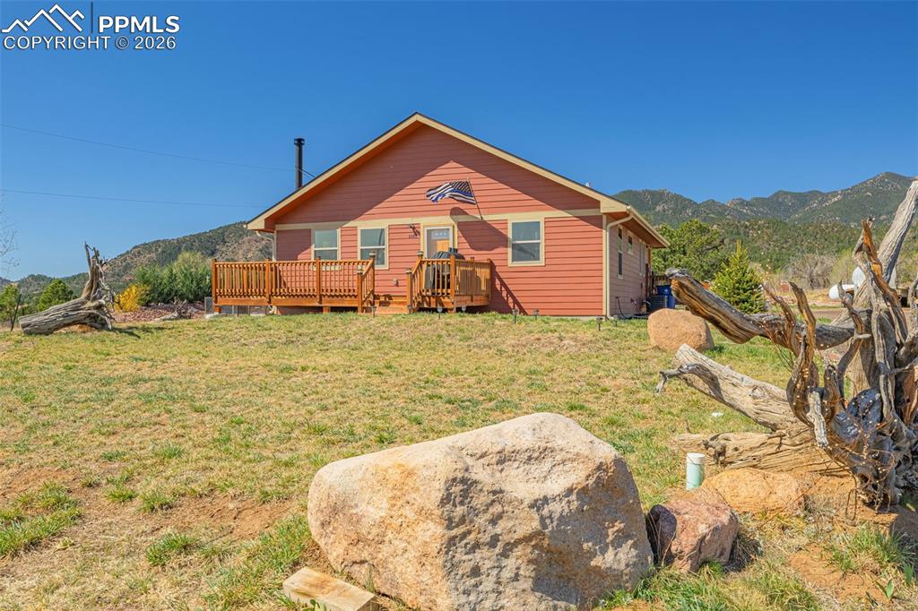 8480 Delaware Road Colorado Springs, CO 80926 - Photo 27 of 49 Front of house featuring a yard and a front deck