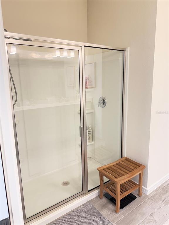 1873 Spring Shower Circle Kissimmee, FL 34744 - Photo 11 of 18 a bathroom with a glass shower door