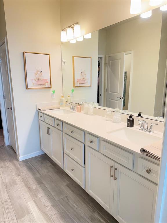 1873 Spring Shower Circle Kissimmee, FL 34744 - Photo 12 of 18 a spacious bathroom with double sink and a mirror