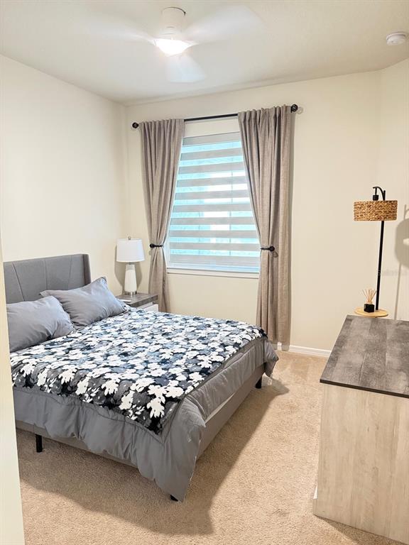 1873 Spring Shower Circle Kissimmee, FL 34744 - Photo 13 of 18 a bedroom with a bed and window