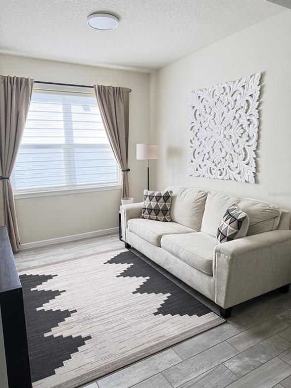 1873 Spring Shower Circle Kissimmee, FL 34744 - Photo 14 of 18 a living room with furniture and a large window