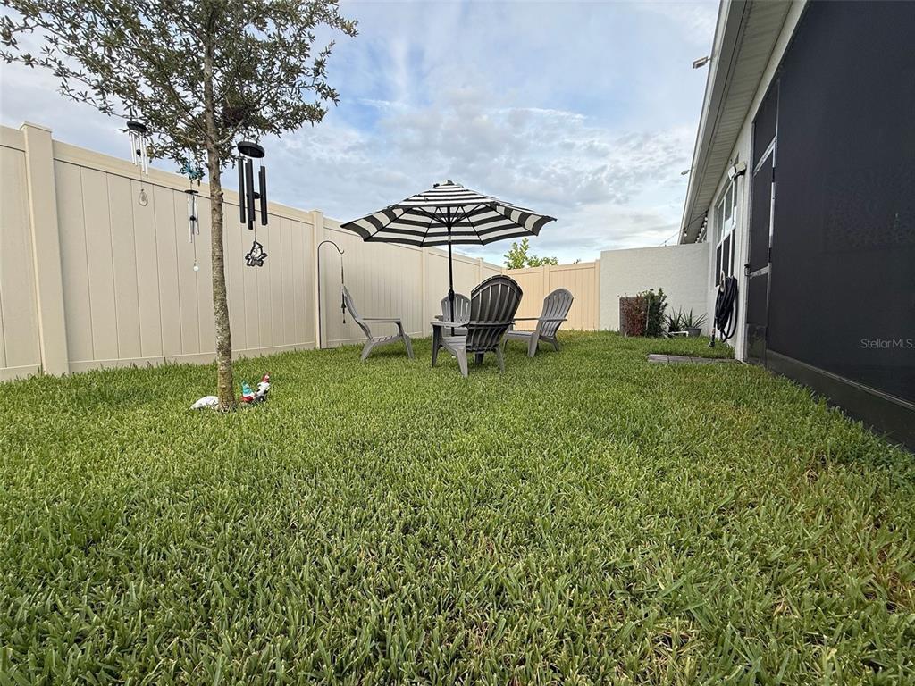 1873 Spring Shower Circle Kissimmee, FL 34744 - Photo 17 of 18 a backyard of a house with table and chairs