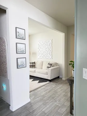 a view of a workspace with furniture and wooden floor