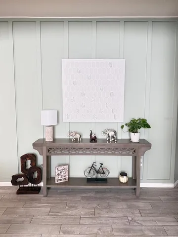 a kitchen with granite countertop a table chairs microwave and cabinets