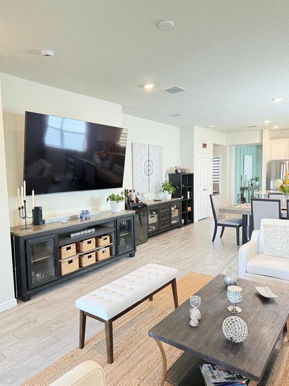 1873 Spring Shower Circle Kissimmee, FL 34744 - Photo 7 of 18 a living room with furniture and a flat screen tv