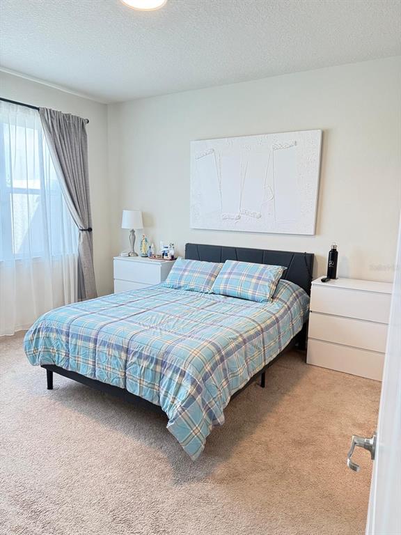 1873 Spring Shower Circle Kissimmee, FL 34744 - Photo 10 of 18 a bedroom with a bed and a couch