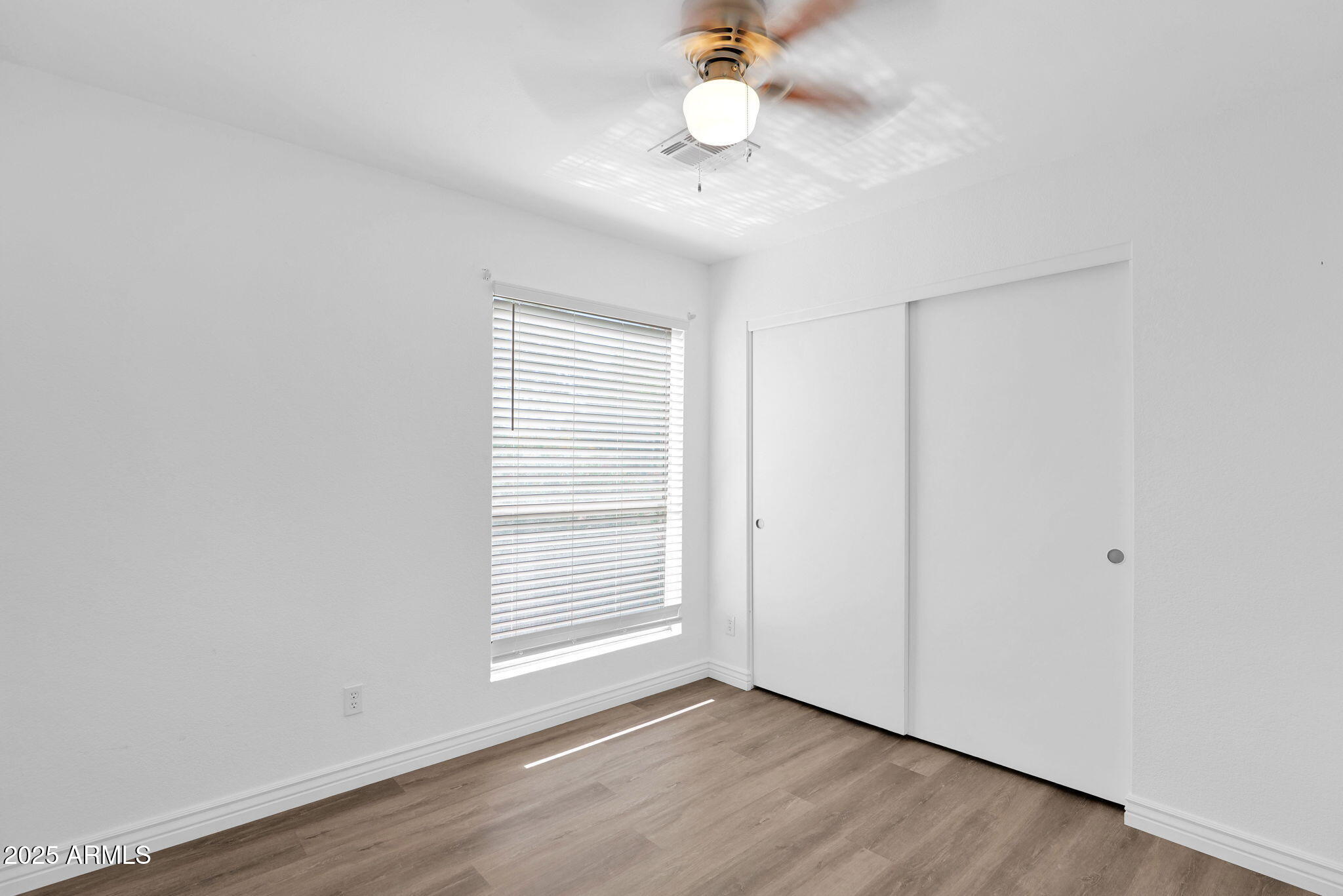 1121 West Manor Street Chandler, AZ 85224 - Photo 14 of 19 an empty room with wooden floor fan and windows