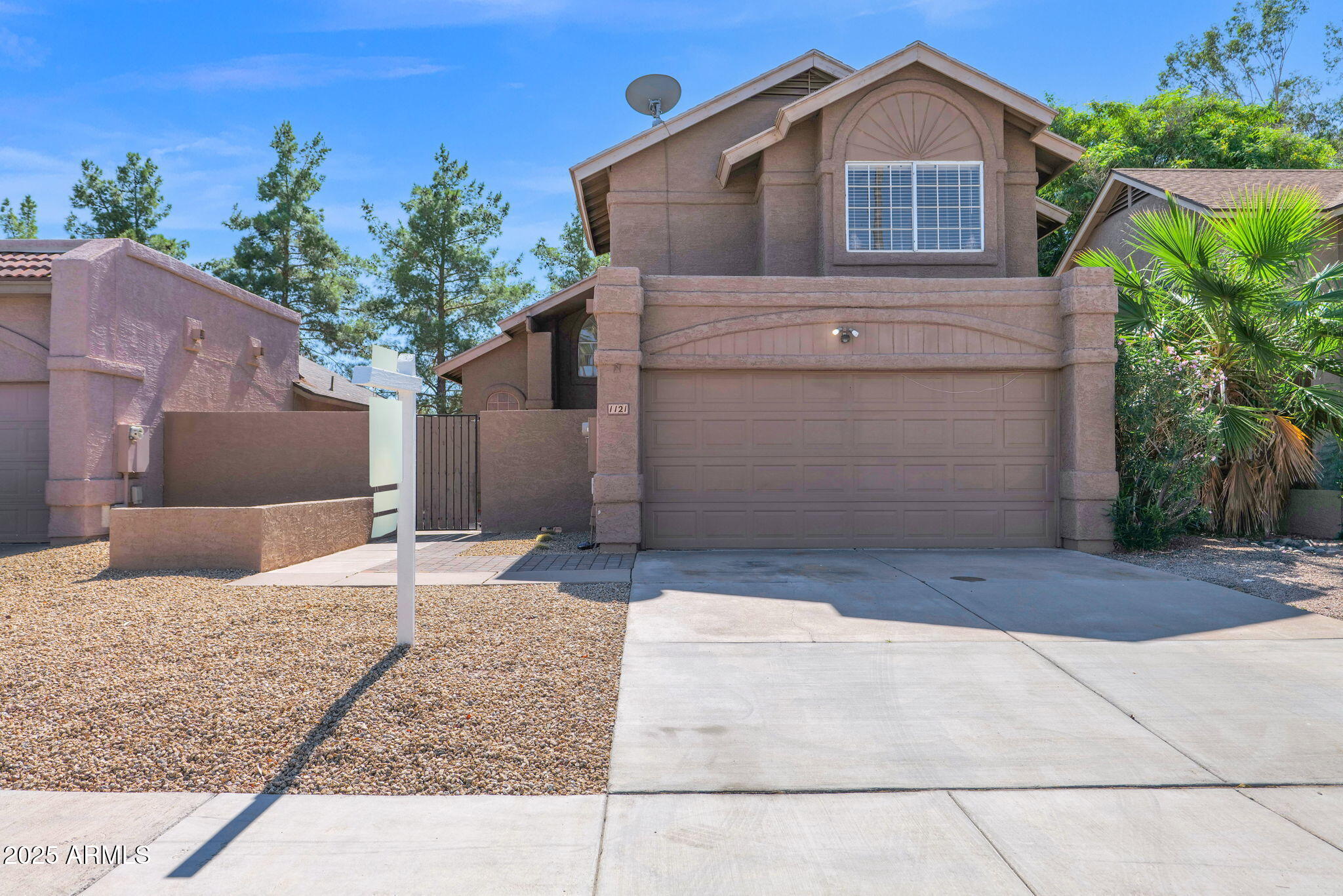 1121 West Manor Street Chandler, AZ 85224 - Photo 18 of 19 a front view of a house with a yard and garage