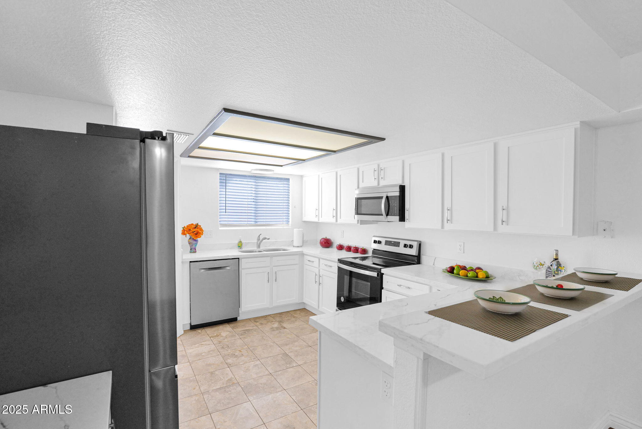 1121 West Manor Street Chandler, AZ 85224 - Photo 3 of 19 a kitchen with a sink a stove and refrigerator
