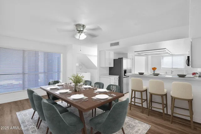 a view of a dining room with furniture and a large window