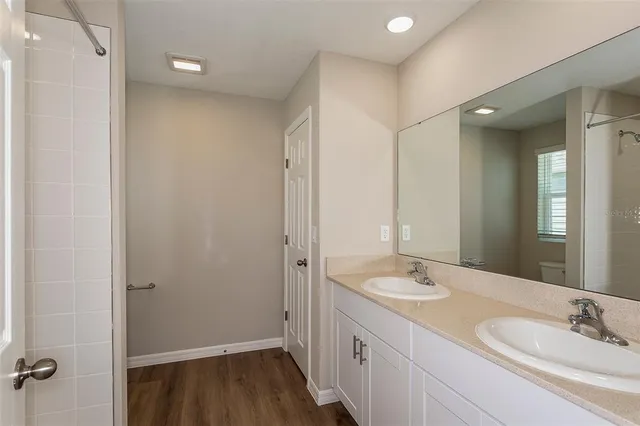 a bathroom with a double vanity sink and mirror