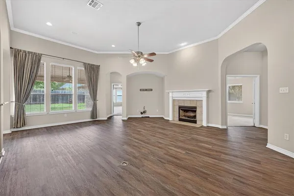 a view of a livingroom with wooden floor fireplace and window