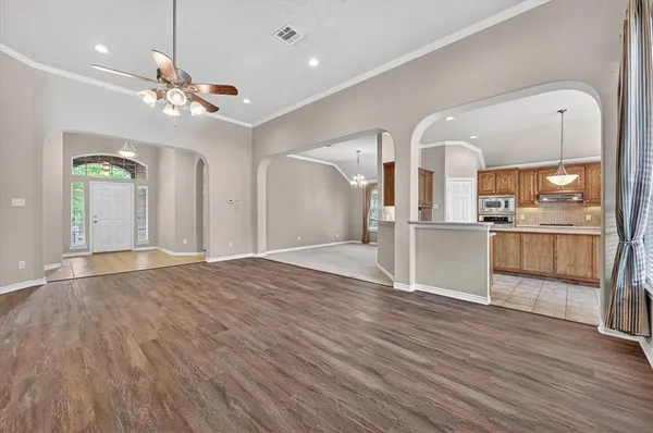a view of a kitchen with wooden floor and a kitchen