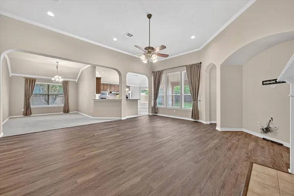wooden floor in an empty room with a window