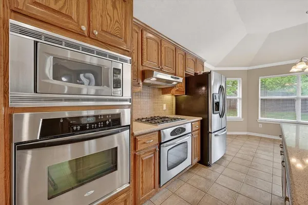 a kitchen with cabinets and steel stainless steel appliances